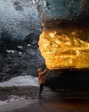 setting-sun-turns-ice-cave-in-iceland-into-amber-by-sarah-bethea.webp